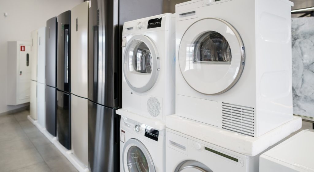 Row of new washing and drying machines in a hypermarket