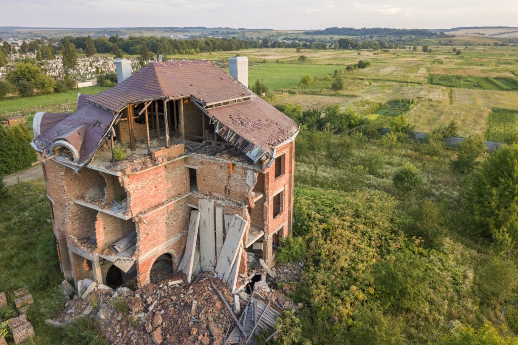 Old ruined building after earthquake. A collapsed brick house .