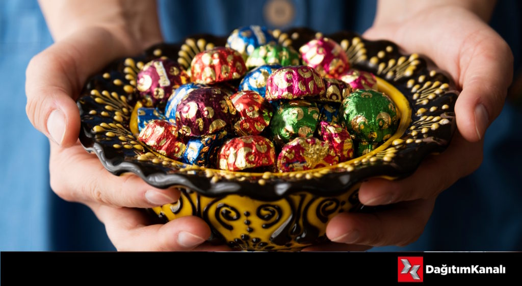 Colorful,Coated,Candies,In,Hand-held,Glass,Bowl.,Girl,Hand.,Traditional